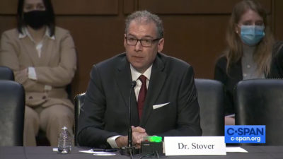 Stover testifying from panel seat